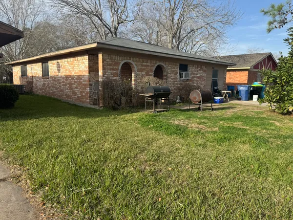 a backyard of a house with table and chairs