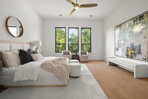 a spacious bedroom with a large bed and a large window