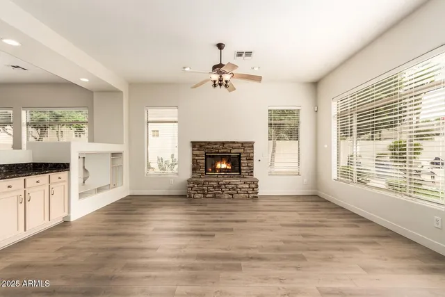 a view of an empty room with a fireplace and a window