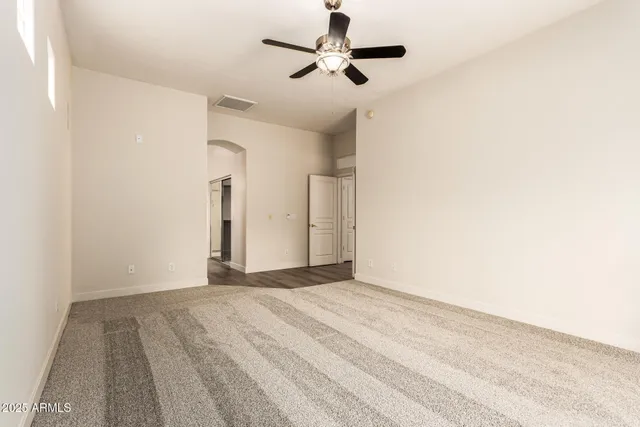 a view of a livingroom with a ceiling fan and window