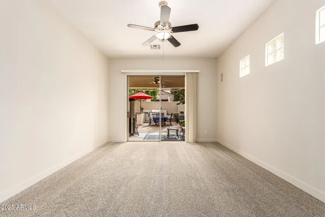 a view of a livingroom with a ceiling fan and a rug