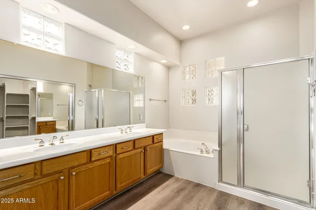 a bathroom with a double vanity sink tub double and mirror