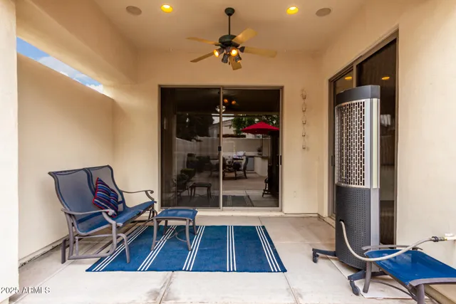 a view of a table and chairs under an umbrella in patio