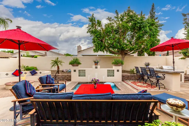 a view of swimming pool with sitting area