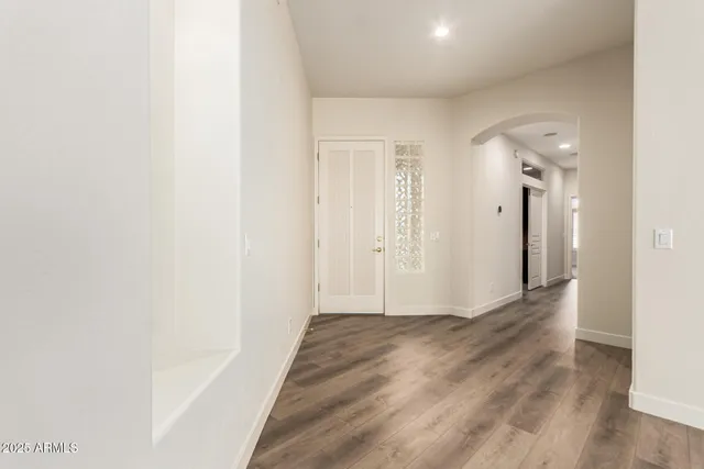 a view of a hallway with wooden floor