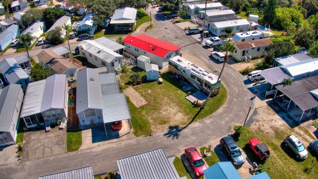an aerial view of a houses with yard