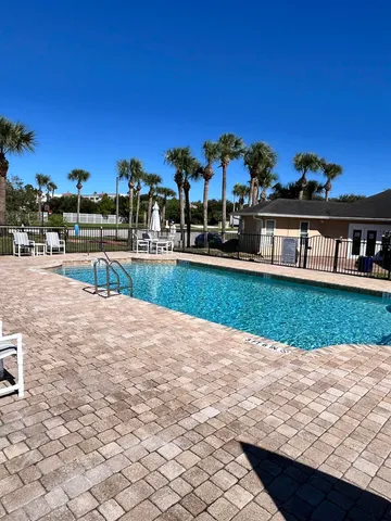 a view of a lake with a bench in the garden