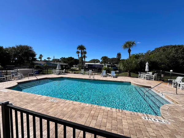 a view of swimming pool with outdoor seating and plants