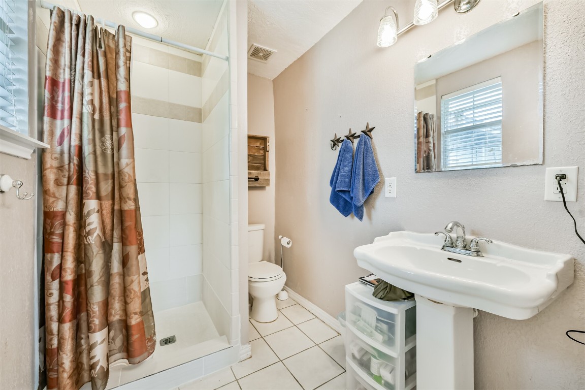 823 Townley Street Channelview, TX 77530 - Photo 13 of 29 a bathroom with a sink toilet and shower