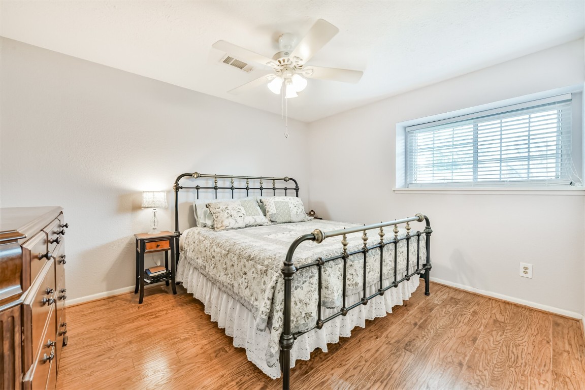 823 Townley Street Channelview, TX 77530 - Photo 14 of 29 a bedroom with a bed and a chandelier