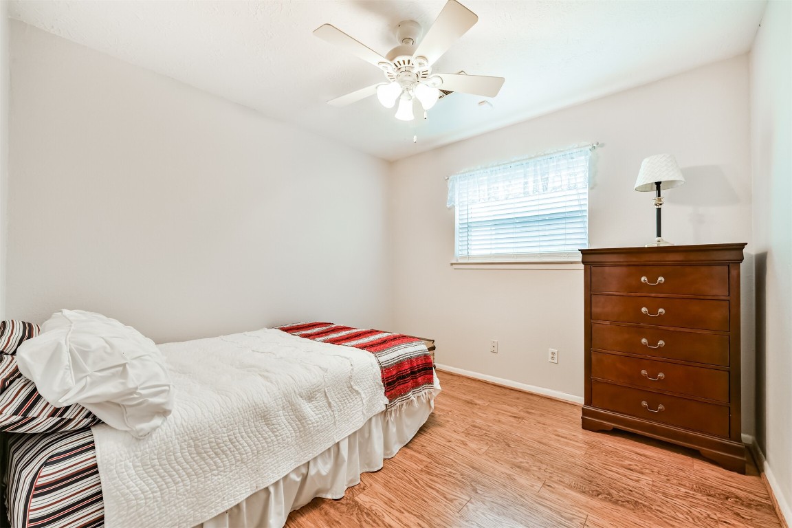 823 Townley Street Channelview, TX 77530 - Photo 17 of 29 a bedroom with a bed and a dresser