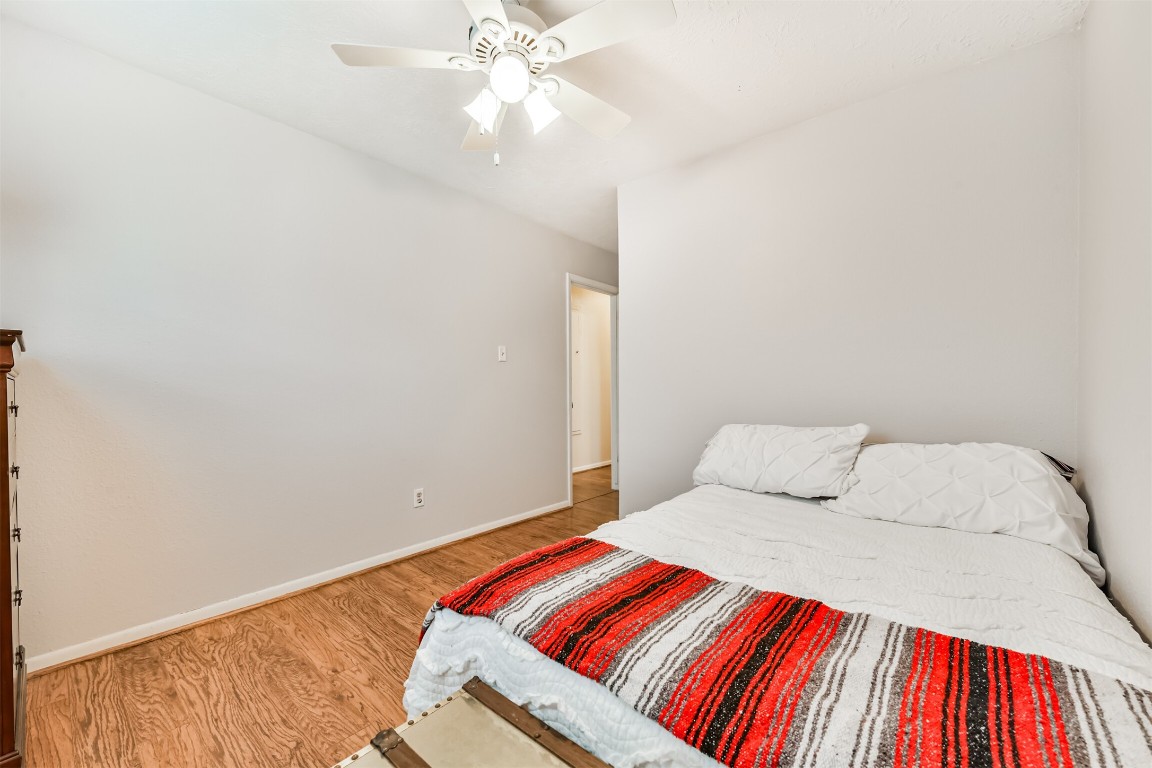 823 Townley Street Channelview, TX 77530 - Photo 18 of 29 a bedroom with a bed and a chandelier