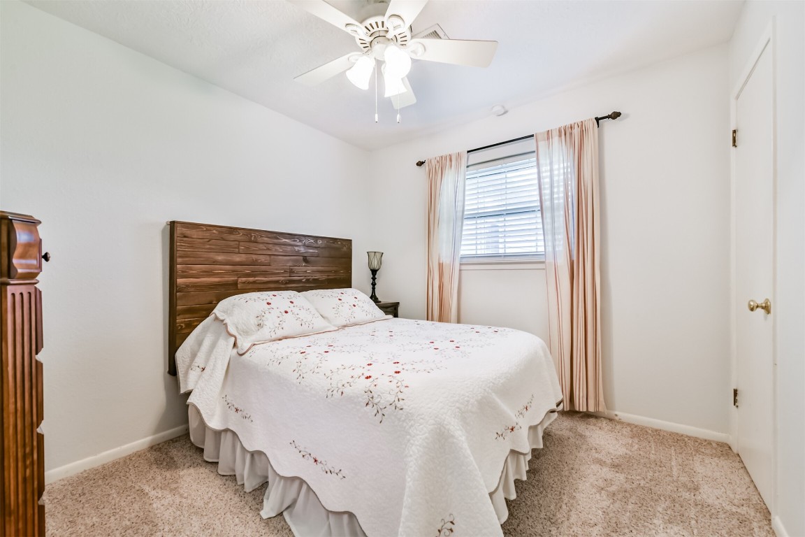 823 Townley Street Channelview, TX 77530 - Photo 19 of 29 a bedroom with a bed and a chandelier