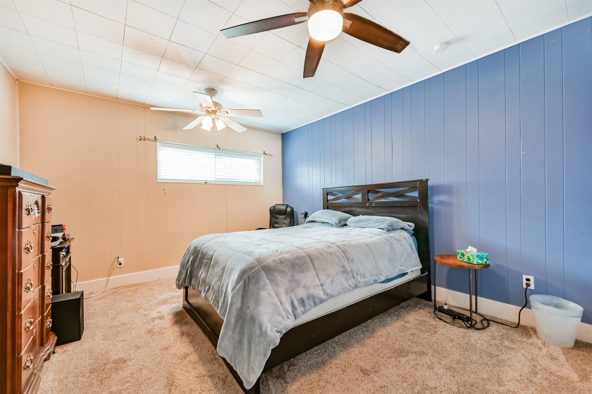 823 Townley Street Channelview, TX 77530 - Photo 22 of 29 a bedroom with a bed dresser and a chandelier