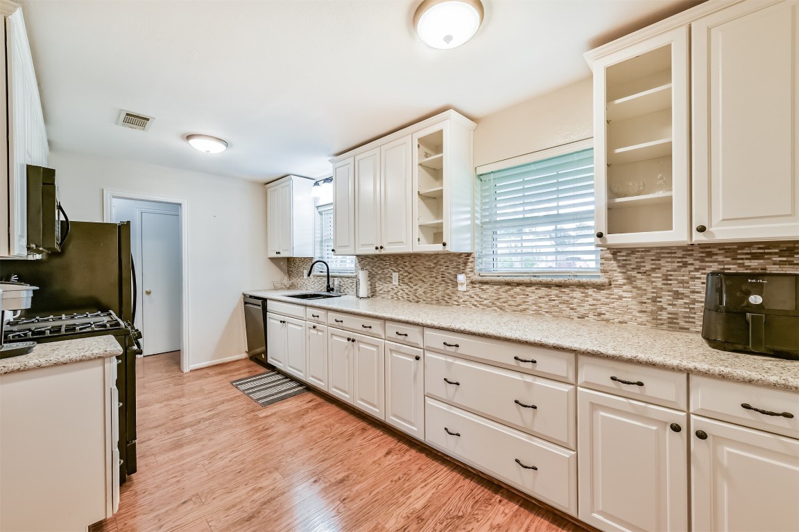 823 Townley Street Channelview, TX 77530 - Photo 7 of 29 a kitchen with granite countertop white cabinets and white appliances