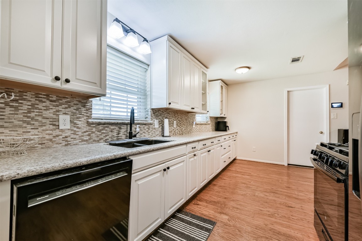 823 Townley Street Channelview, TX 77530 - Photo 8 of 29 a kitchen with granite countertop wooden cabinets stainless steel appliances and a counter space
