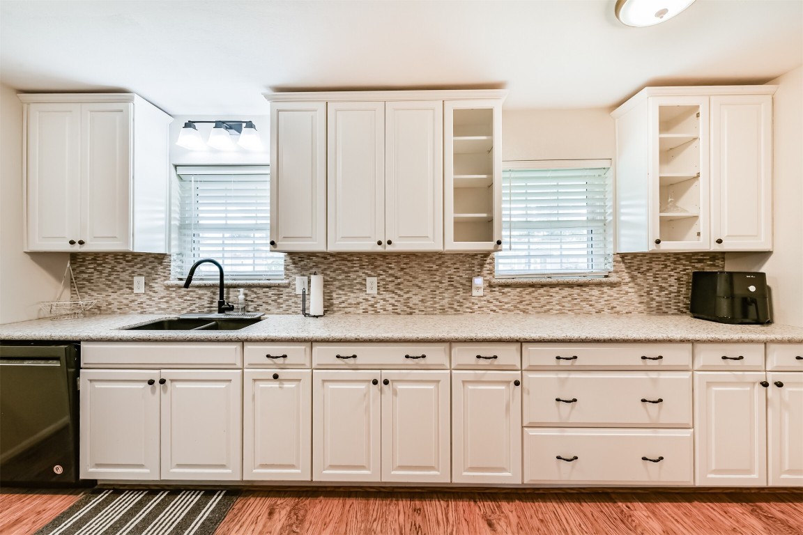 823 Townley Street Channelview, TX 77530 - Photo 9 of 29 a kitchen with granite countertop white cabinets and sink