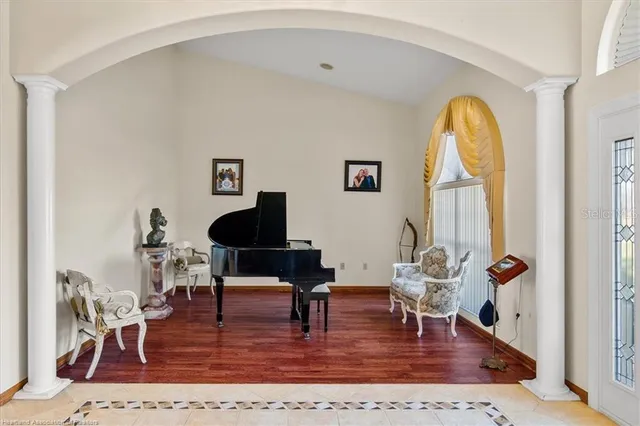 a living room with furniture a dining table and wooden floor
