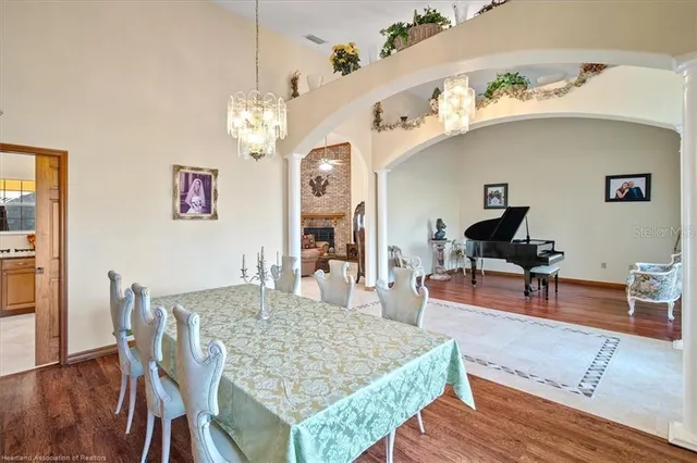 a living room with dining table and wooden floor
