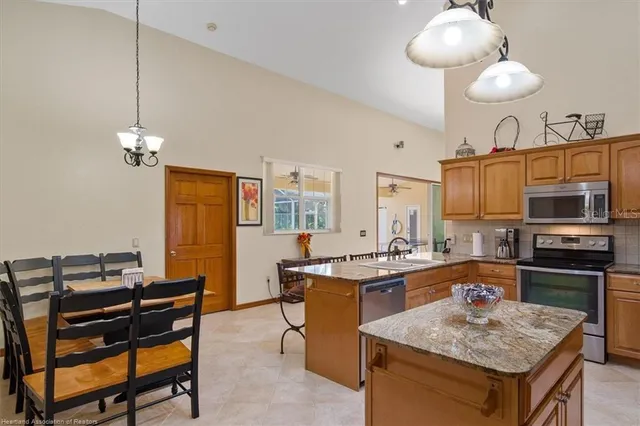 a kitchen with a stove a sink a kitchen island a stove and a cabinets