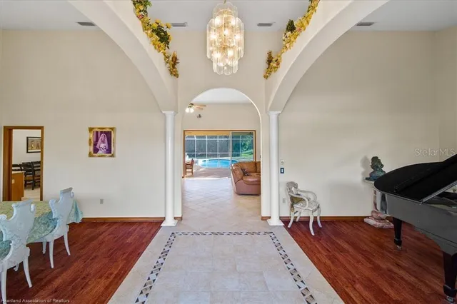 a living room with furniture and a chandelier