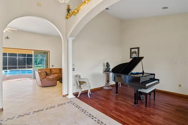 a living room with furniture and wooden floor