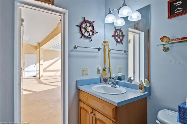a bathroom with a sink vanity and a mirror