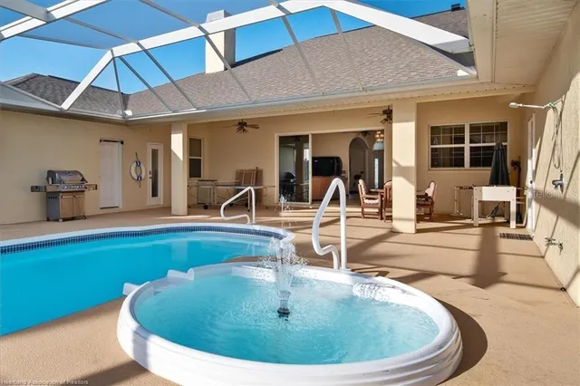 a view of a swimming pool with outdoor seating