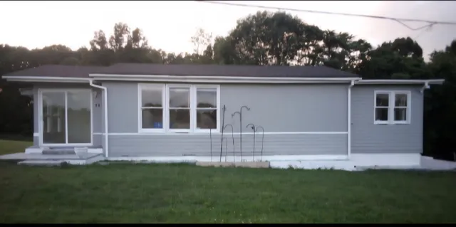 a front view of a house with a garden