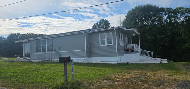 a view of a backyard with wooden fence