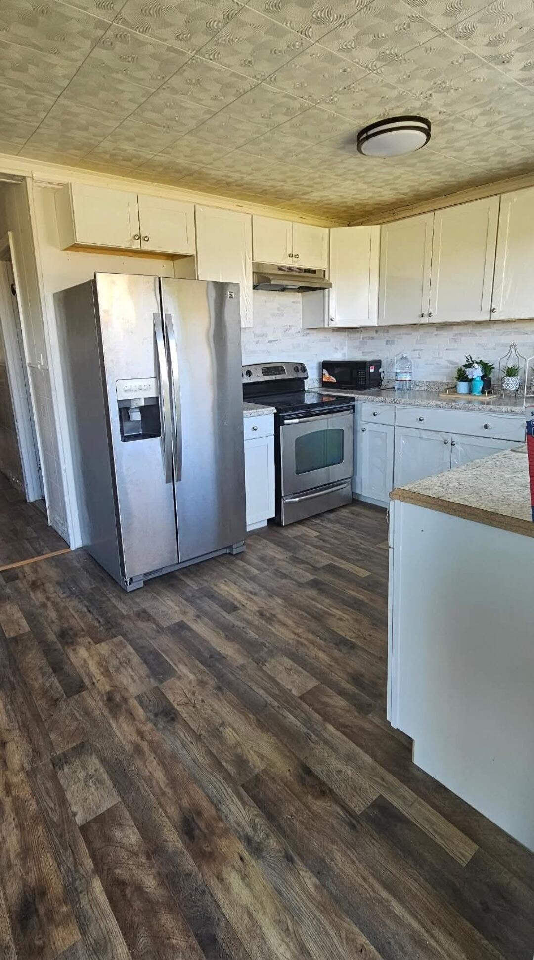 341 George Martin Drive Ridgeway, VA 24148 - Photo 10 of 11 a kitchen with granite countertop white cabinets and stainless steel appliances