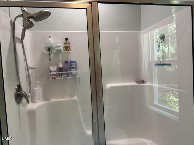 574 East Ridge Avenue Liberty, NC 27298 - Photo 24 of 28 a bathroom with a glass shower door