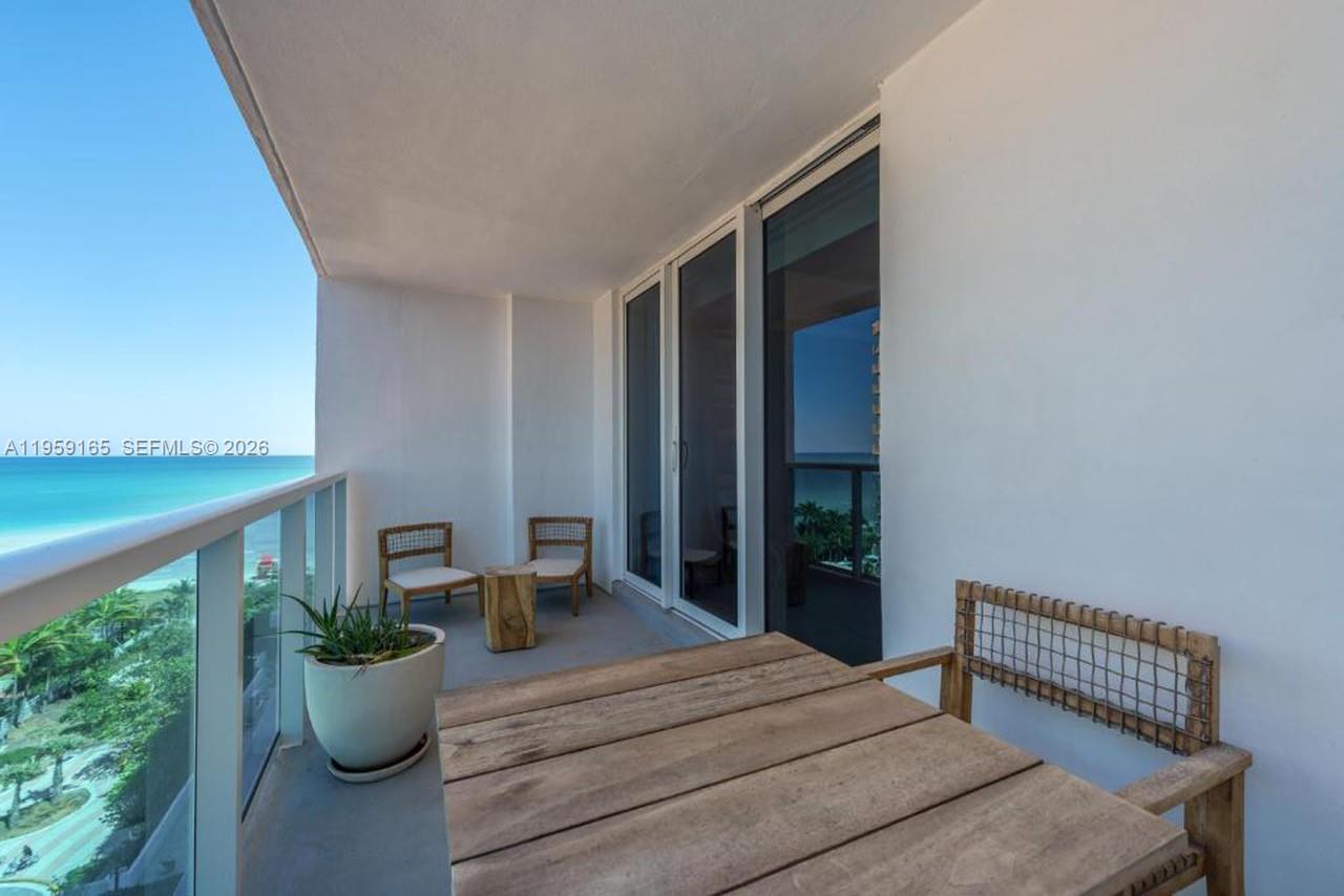 102 24th Street, Unit 1007 Miami Beach, FL 33139 - Photo 5 of 23 a bedroom with furniture and a potted plant