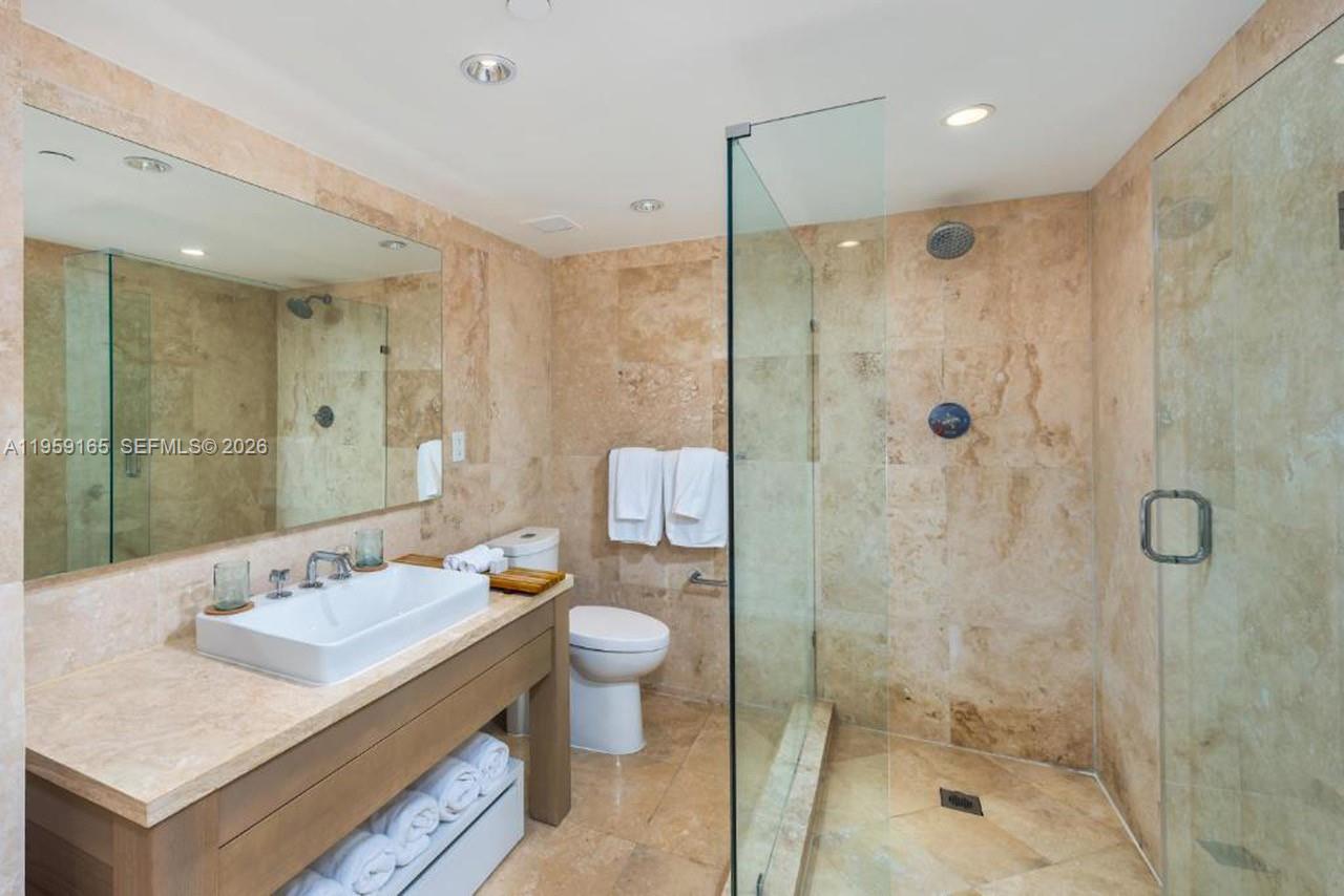 102 24th Street, Unit 1007 Miami Beach, FL 33139 - Photo 6 of 23 a bathroom with a sink toilet double vanity and shower