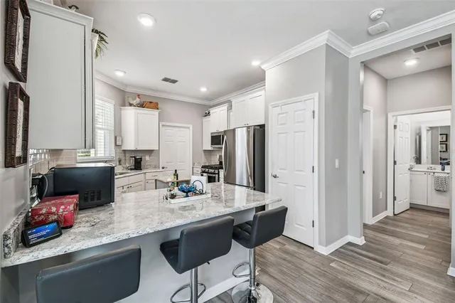 a kitchen with granite countertop a sink and a stove