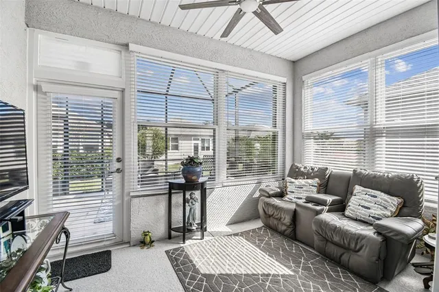 a living room with furniture and large windows