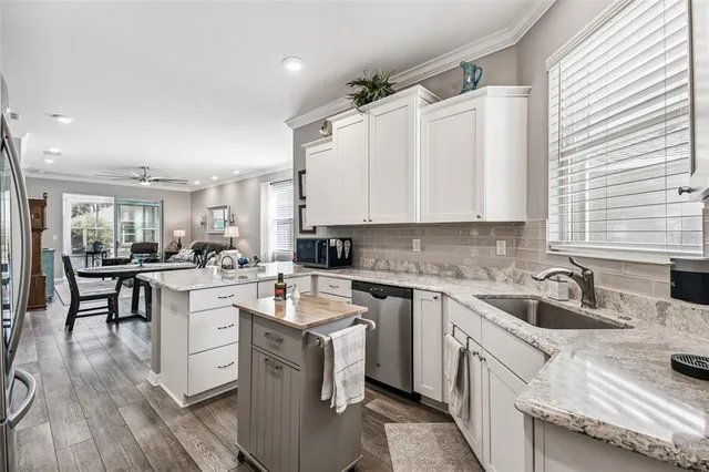 a kitchen with a sink stove cabinets and refrigerator