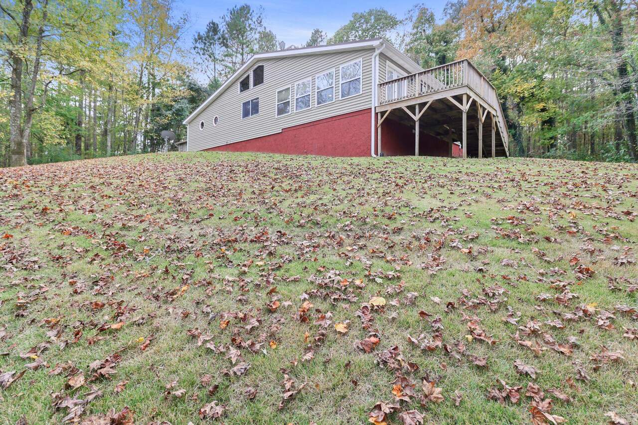 1768 4 Notch Road Carrollton, GA 30116 - Photo 1 of 1 a view of a wooden house with a yard