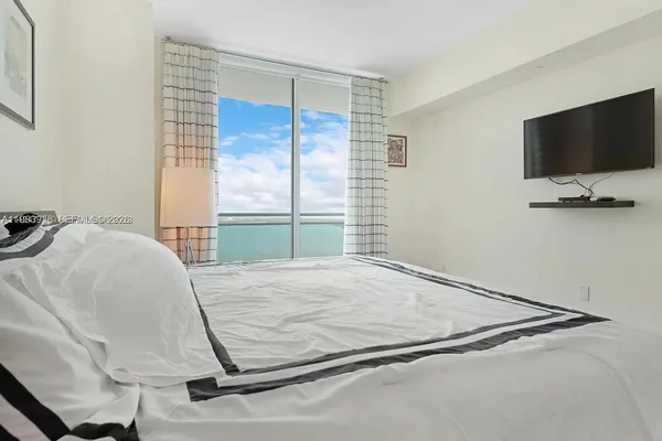 a room with a bed and a flat screen tv