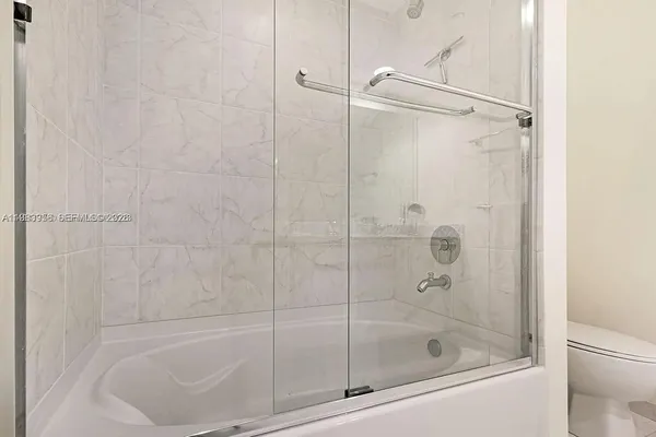 a bathroom with a shower and toilet
