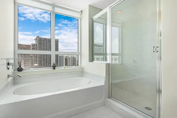 a bathroom with a bathtub and a shower
