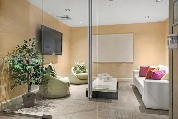 a living room with furniture and a potted plant