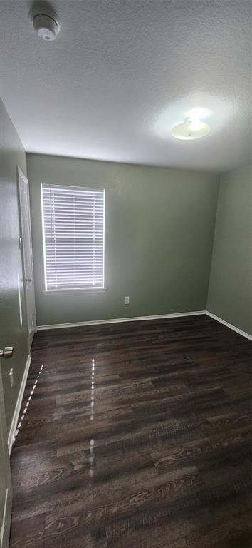 3709 Northpointe Drive Denton, TX 76207 - Photo 16 of 29 a view of an empty room with wooden floor and a window