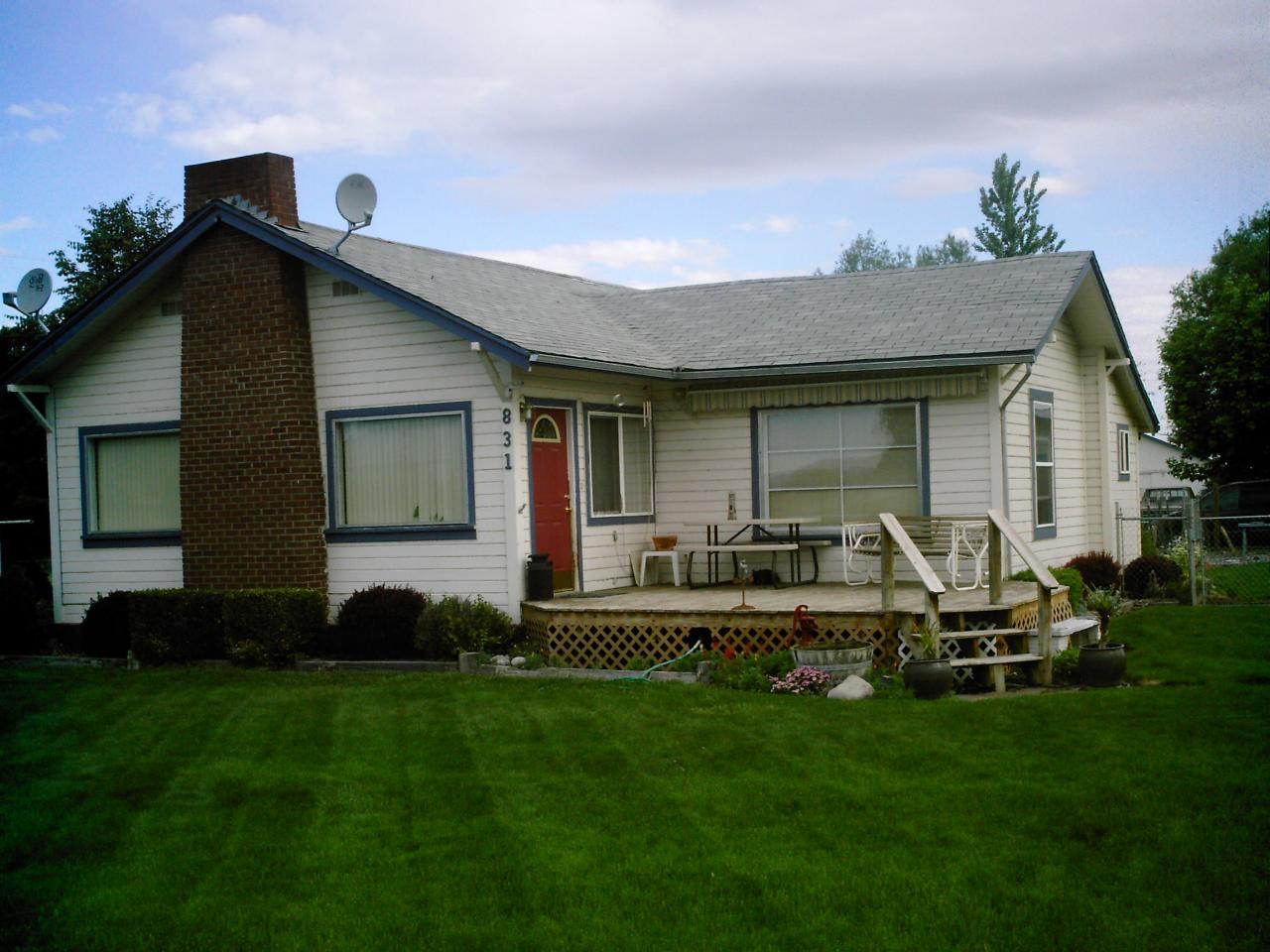 831 Bonnieview Road Grandview, WA 98930 - Photo 1 of 3 a front view of house with yard and outdoor seating
