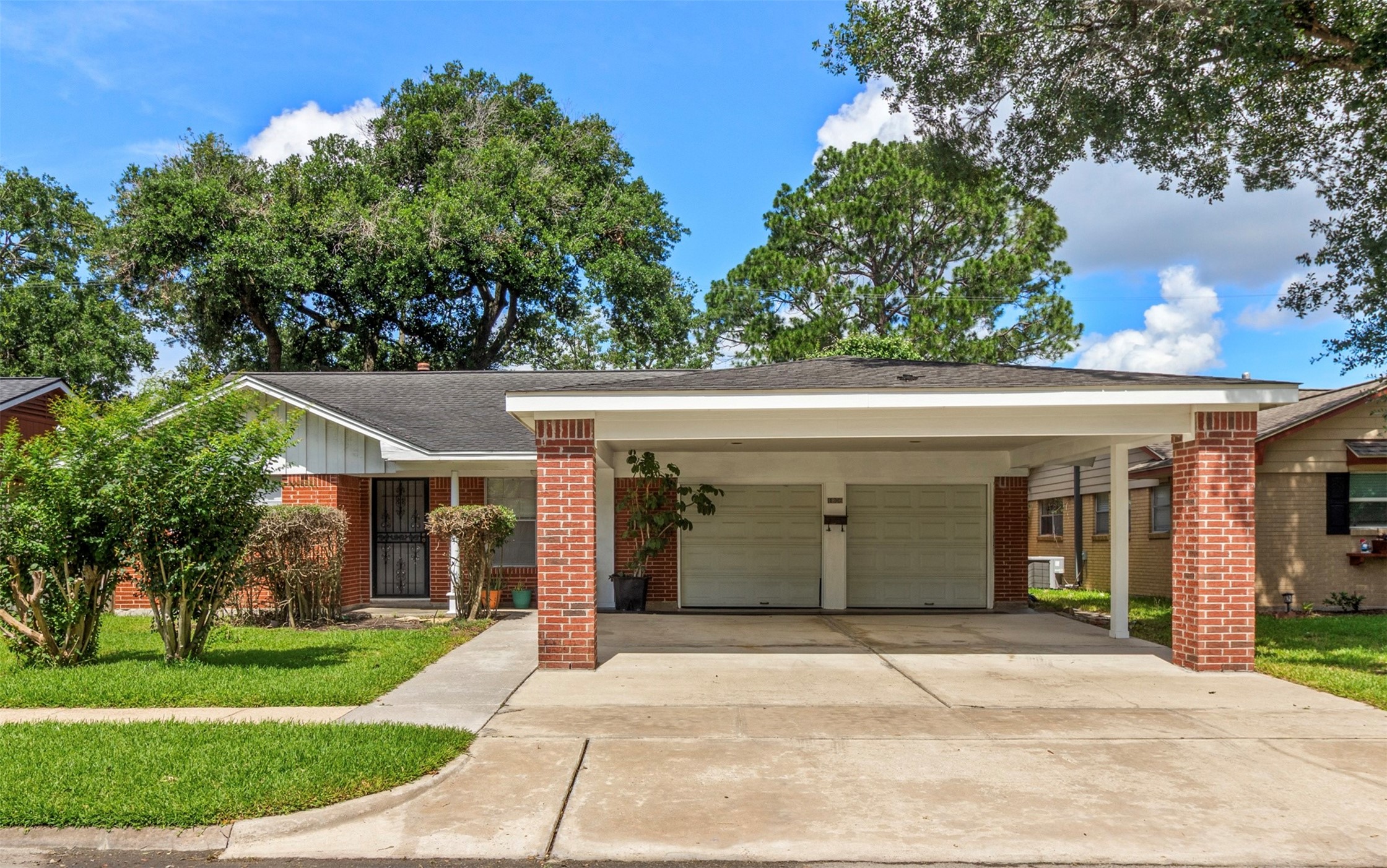 Front view of home. 2 car garage with spacious driveway and covered carport