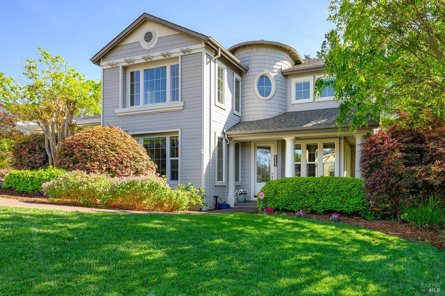 a front view of a house with a garden