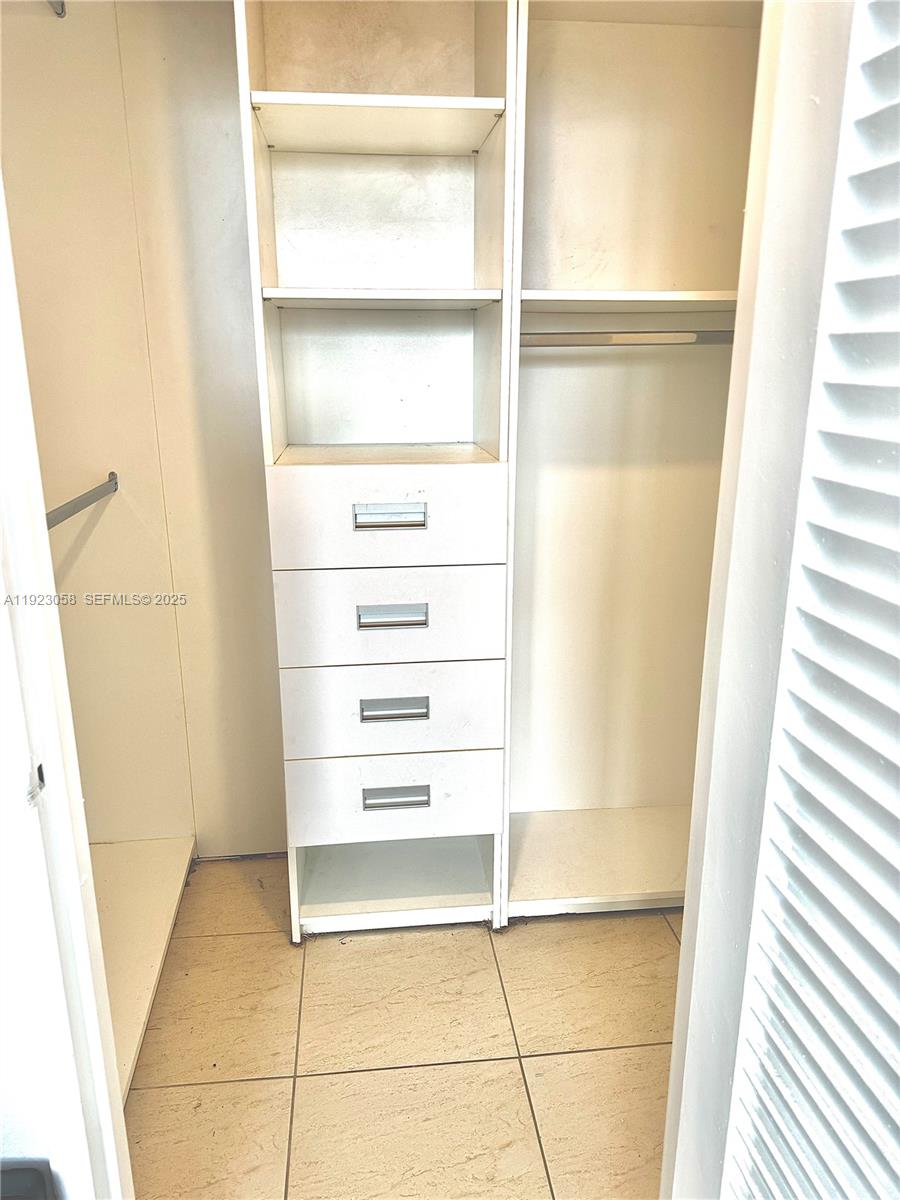 1300 Lincoln Road, Unit C903 Miami Beach, FL 33139 - Photo 12 of 13 a view of walk in closet with empty racks