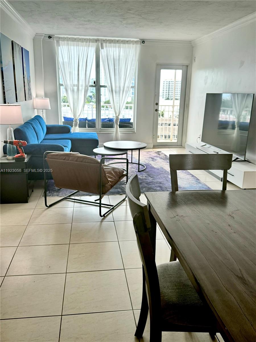 1300 Lincoln Road, Unit C903 Miami Beach, FL 33139 - Photo 6 of 13 a living room with furniture and a large window