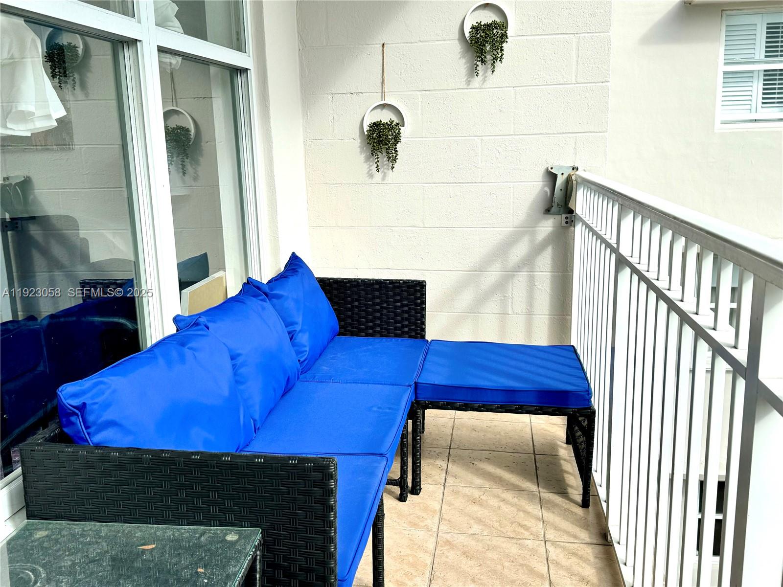 1300 Lincoln Road, Unit C903 Miami Beach, FL 33139 - Photo 9 of 13 a bedroom with a bed and a window