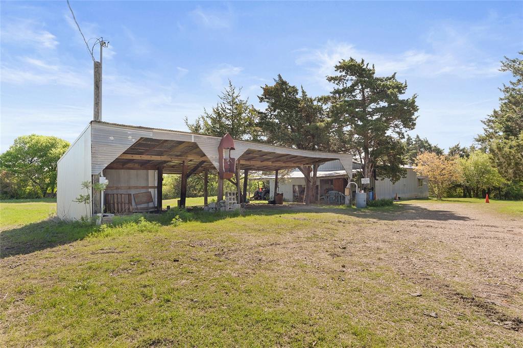 821 Ewing Road Ferris, TX 75125 - Photo 27 of 40 a house with a yard